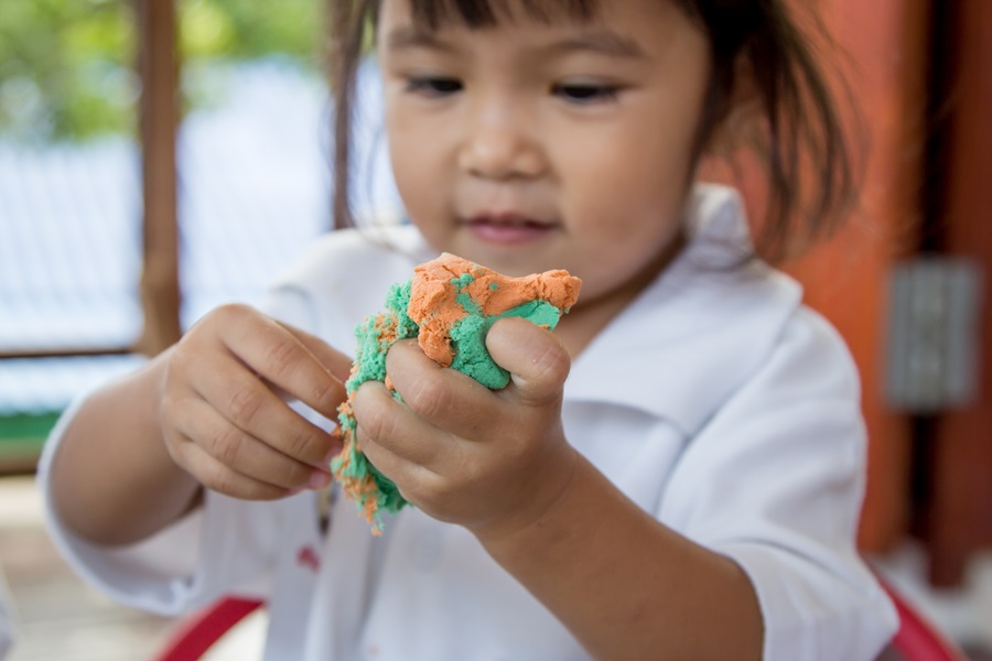 kid playing with dough