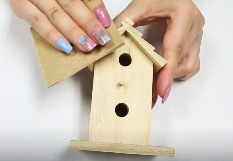 sanding the birdhouse